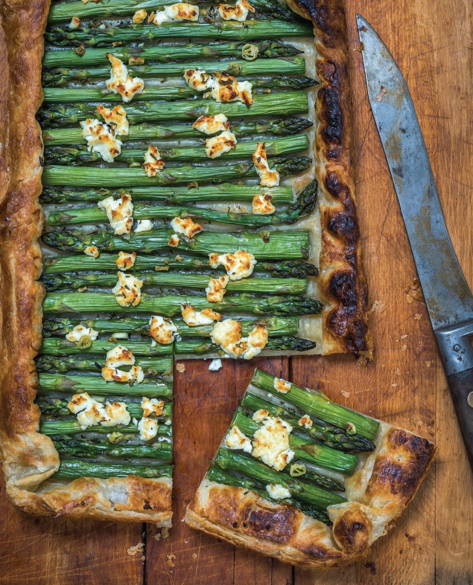 Close-up view of Asparagus and Goat Cheese Tart with a knife