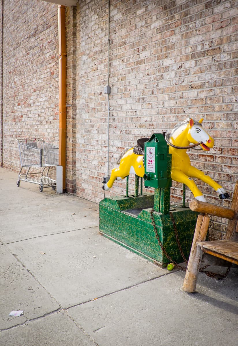 Coin-operated horse ride outside a store