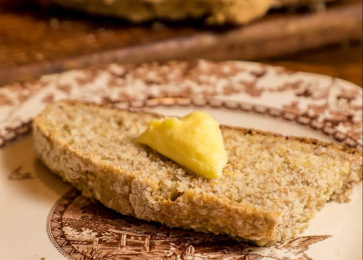 Slice of Irish Wheaten Bread with a dollop of butter on top.
