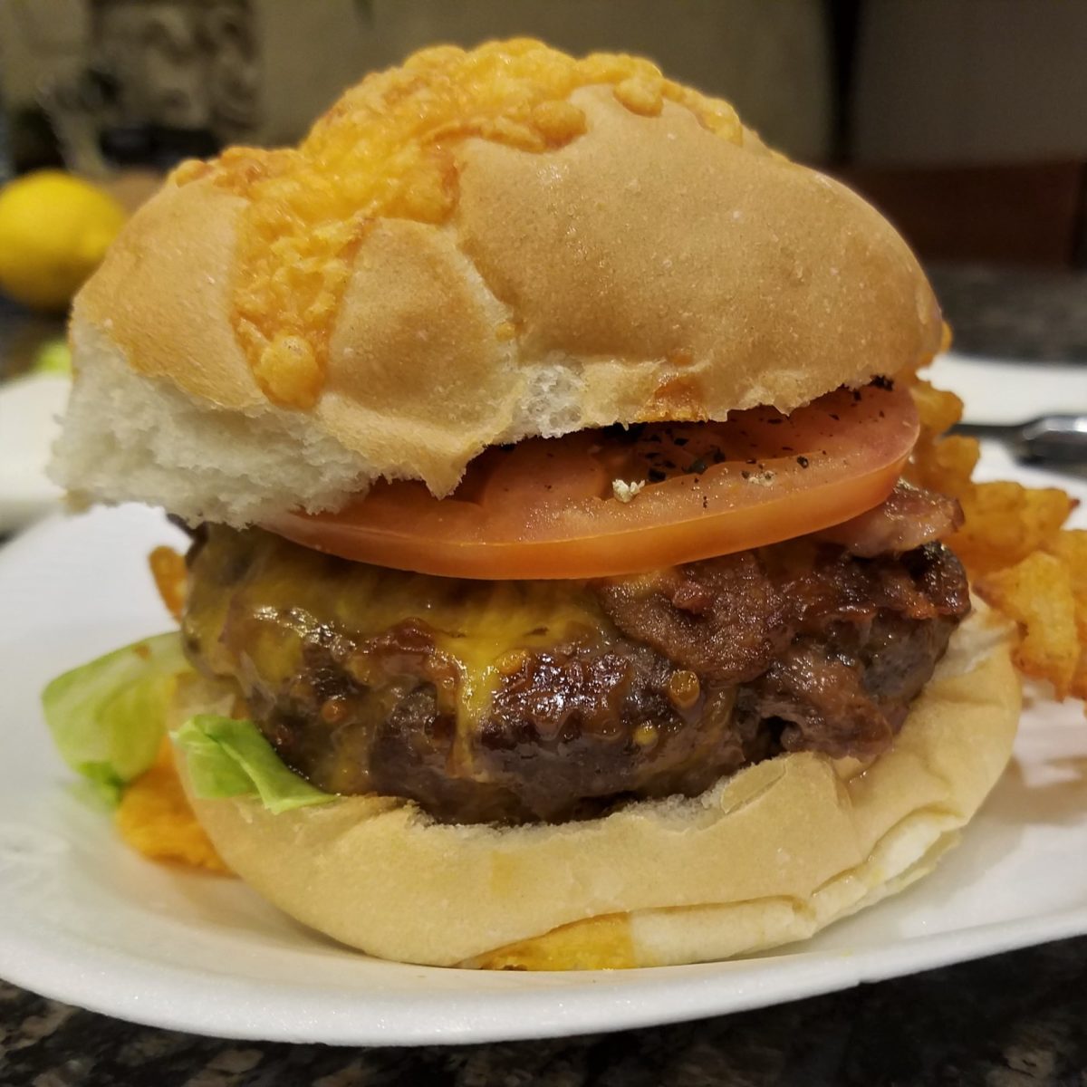 Cheeseburger with lettuce, tomato, and a crispy bun.