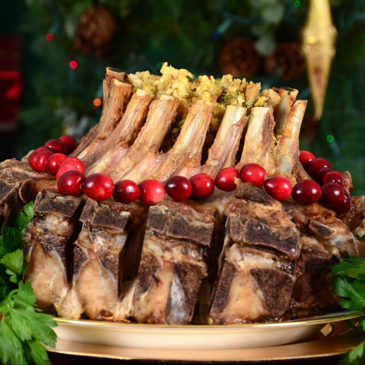 Crown roast of pork on a plate garnished with cranberries