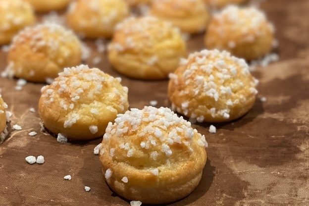 Sugar-topped chouquettes on a table