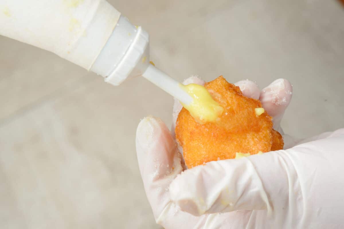 Bismark pastry tip piping cream into a pastry