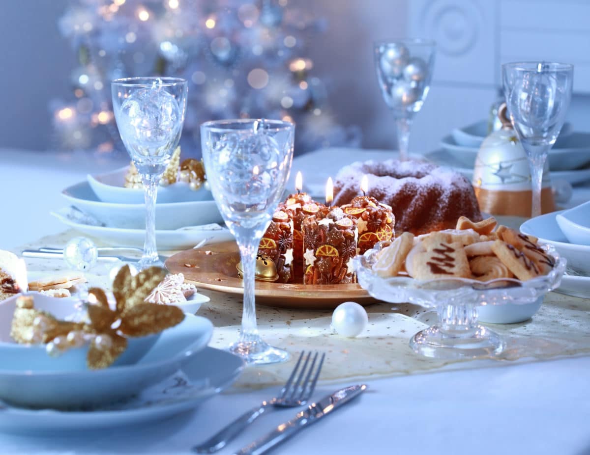 Blue and white luxury place setting with festive decorations.