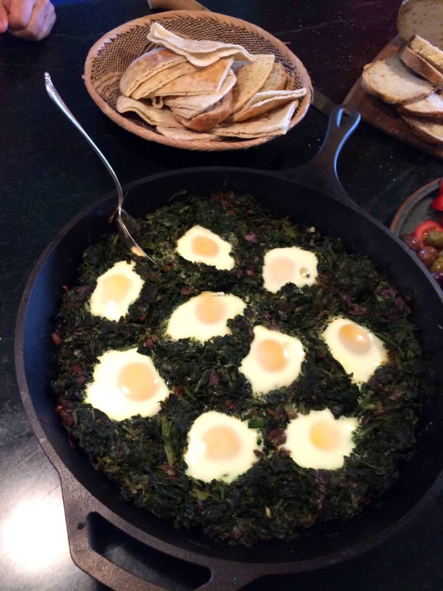 A skillet of Espinac Yumatar, spinach mixed with eggs.