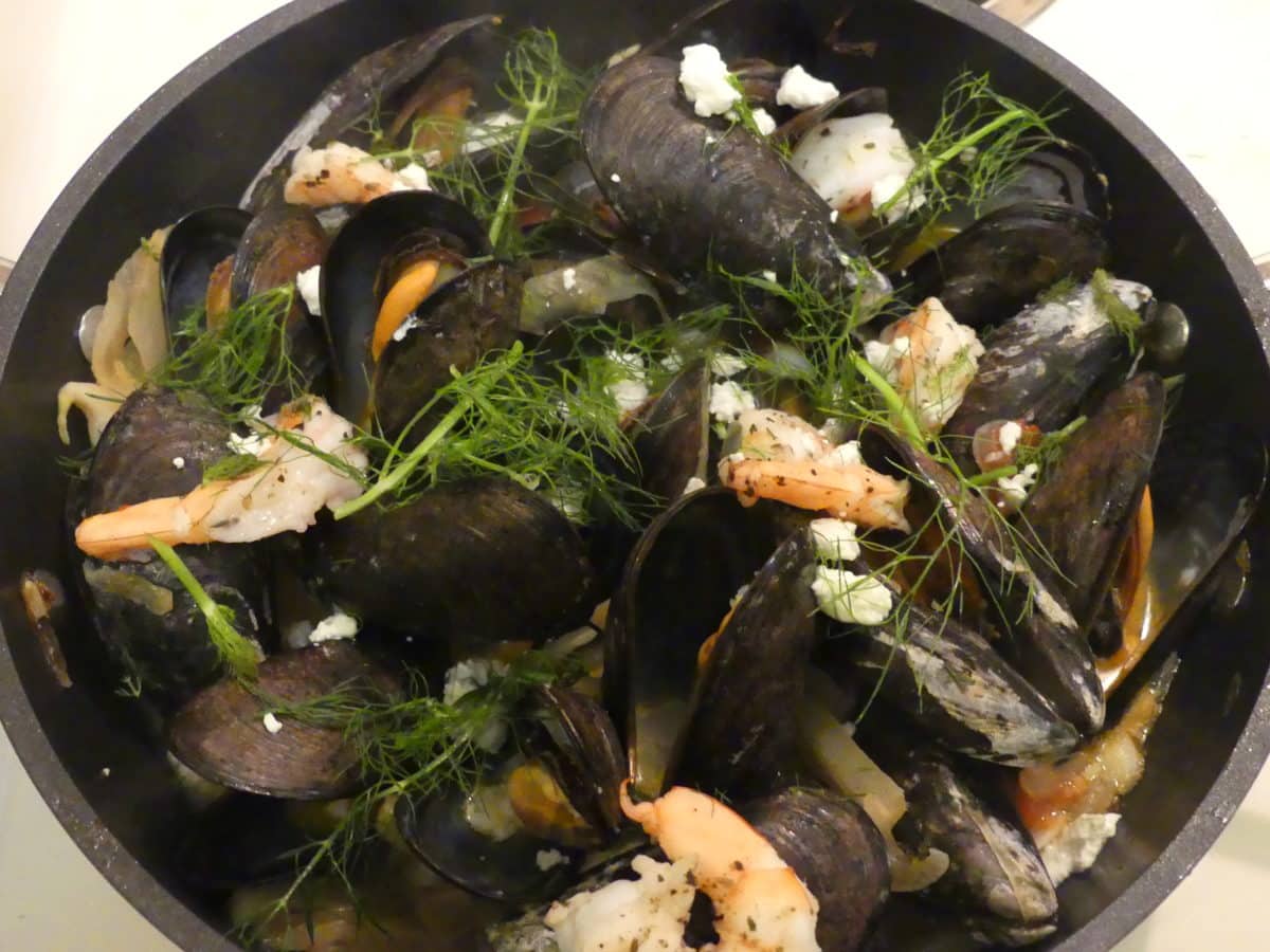 Close-up view of mussels and shrimp with fennel and feta