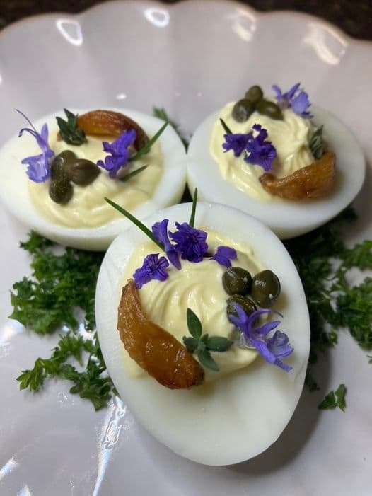 Eggs stuffed with labne and herbs, garnished with flowers