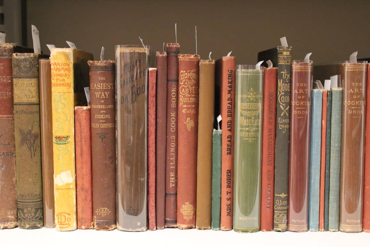 Assortment of vintage recipe books on a shelf