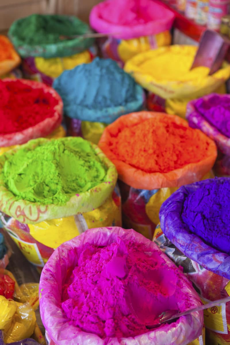 Piles of vibrant Holi powders in various colors meant for festivities in Indian culture.