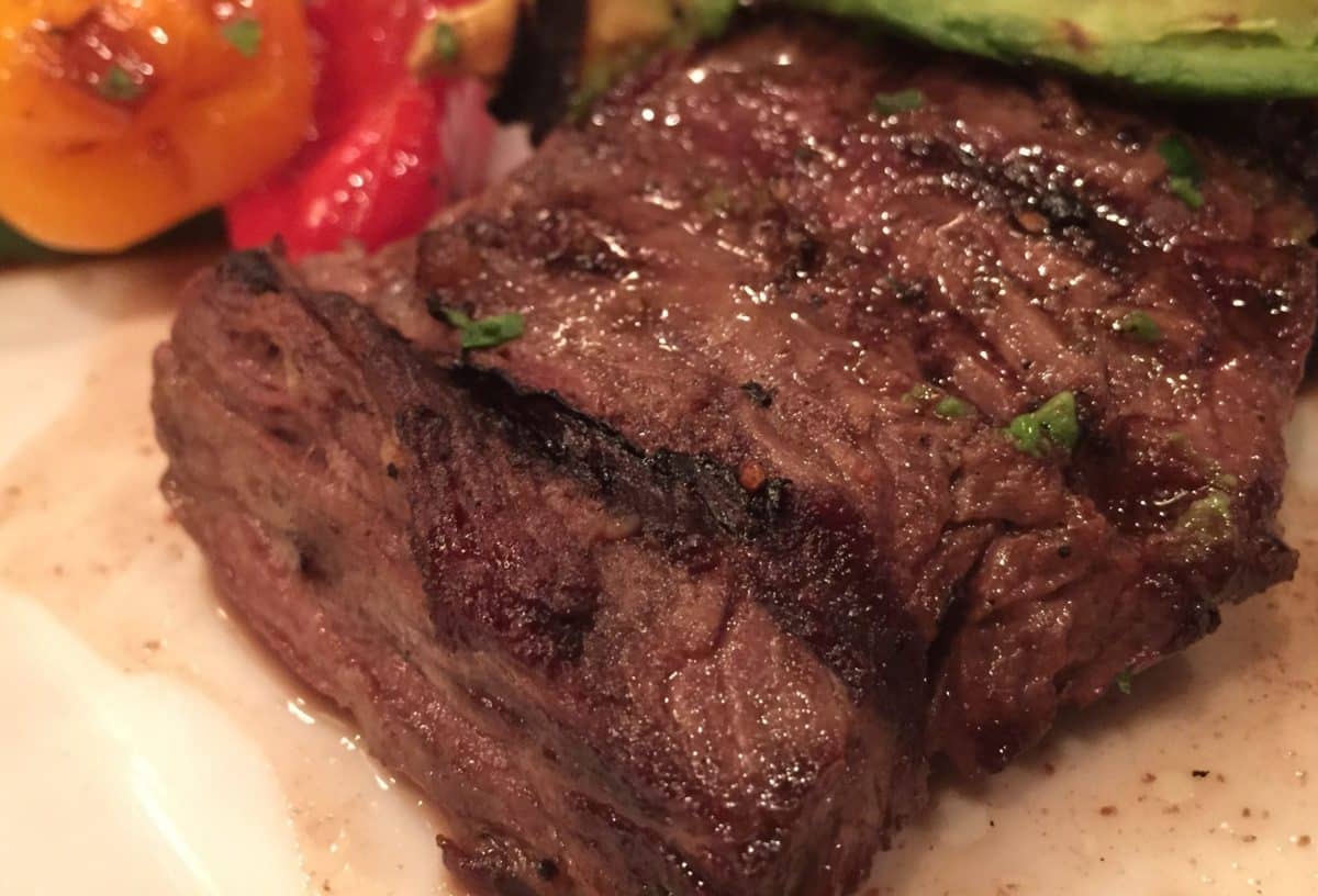 Close-up view of a perfectly cooked skirt steak.