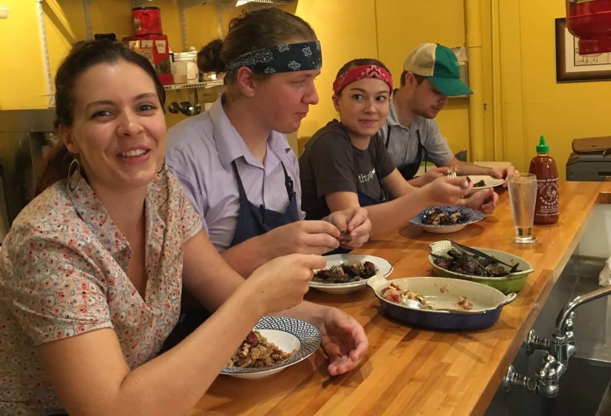 Kitchen staff gathered and enjoying a meal together