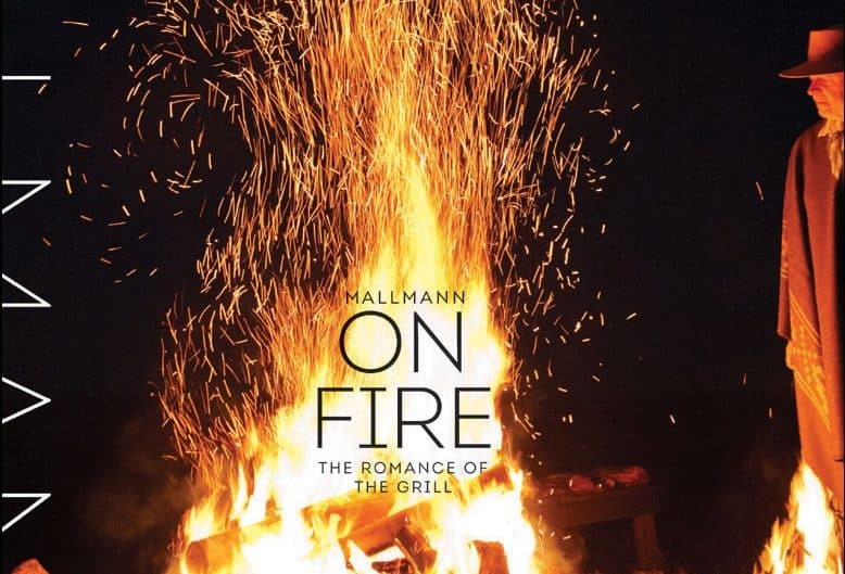 Close-up view of the "Mallmann On Fire" book cover with vibrant flames.