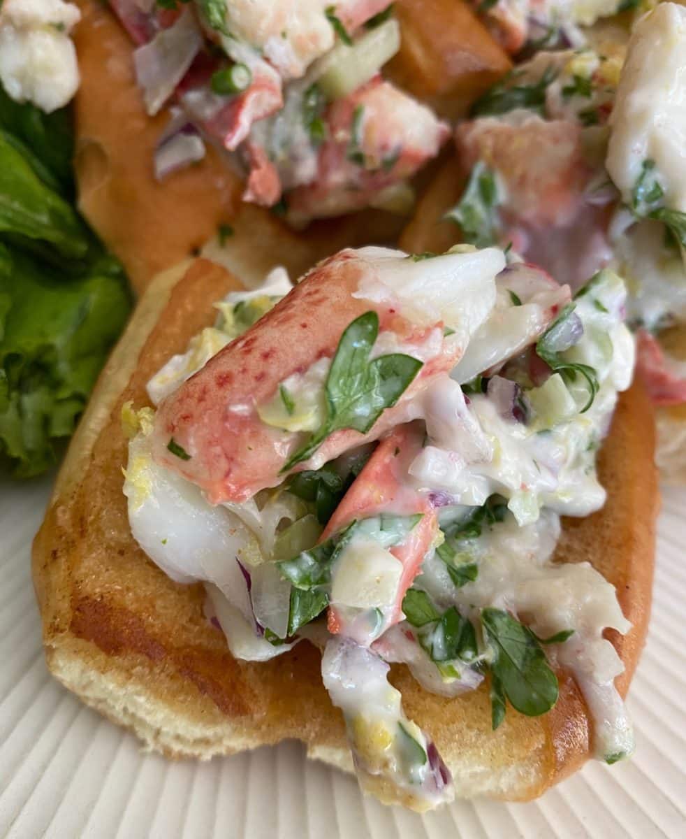 Miniature lobster roll with fresh herbs.