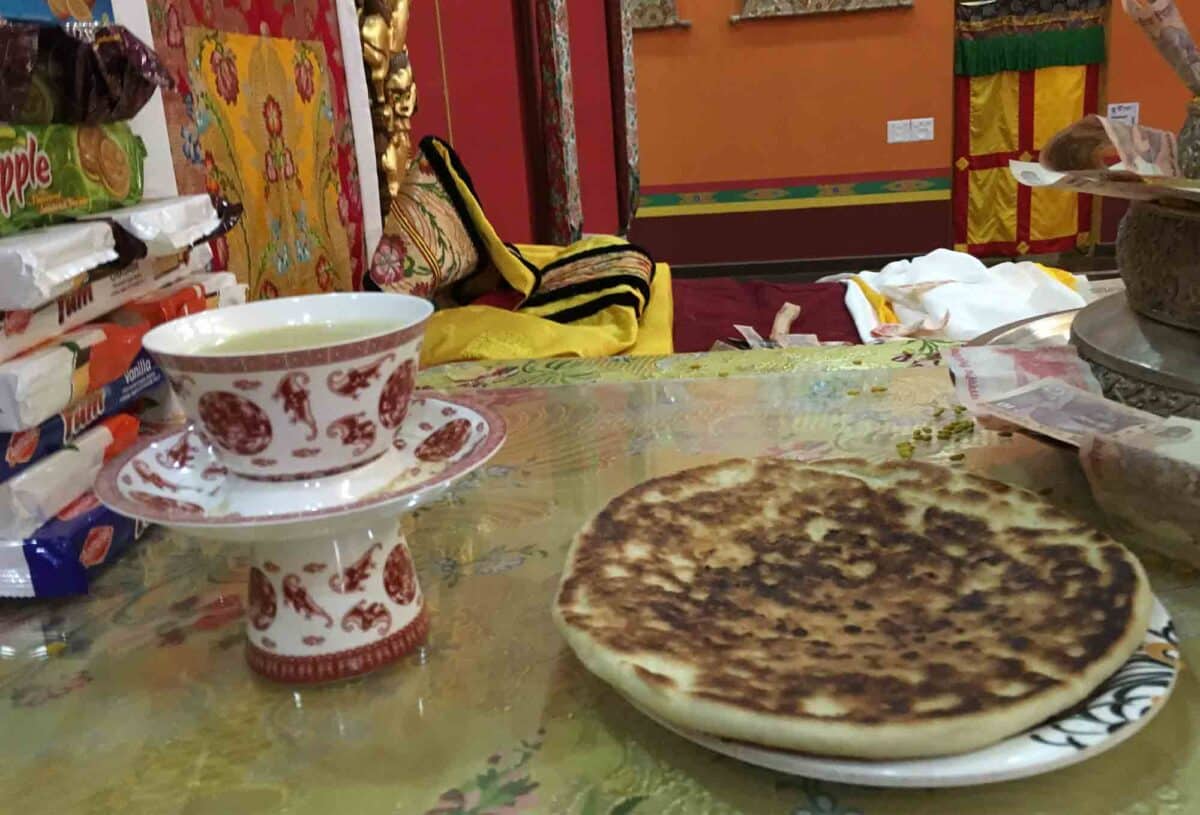Table with cup of tea and plate of pah lay