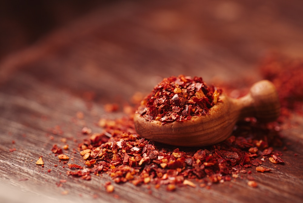 Traditional harissa spice mix on wooden background