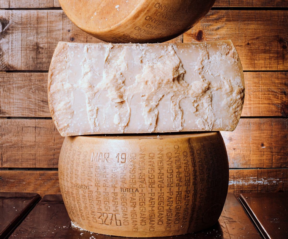 Close-up of a wheel of Parmigiano Reggiano cheese with the distinct markings