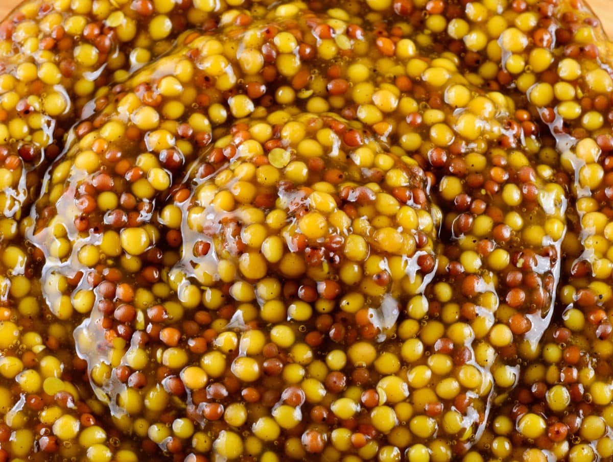 Zoomed in view of glistening pickled mustard seeds.