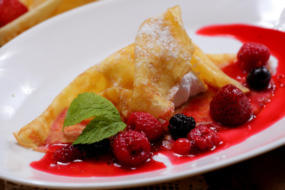 Pancakes with fresh berries and raspberry coulis