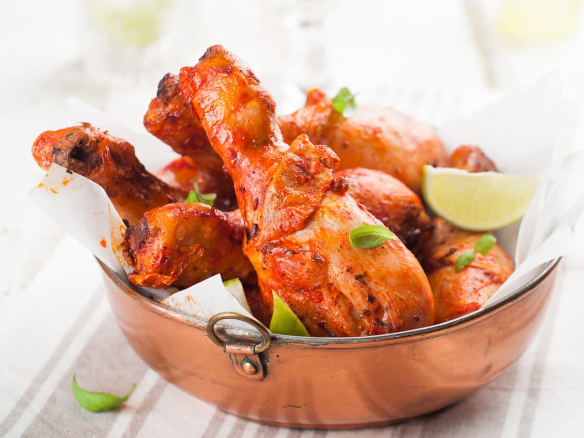 Flavorful roasted chicken legs in a copper bowl