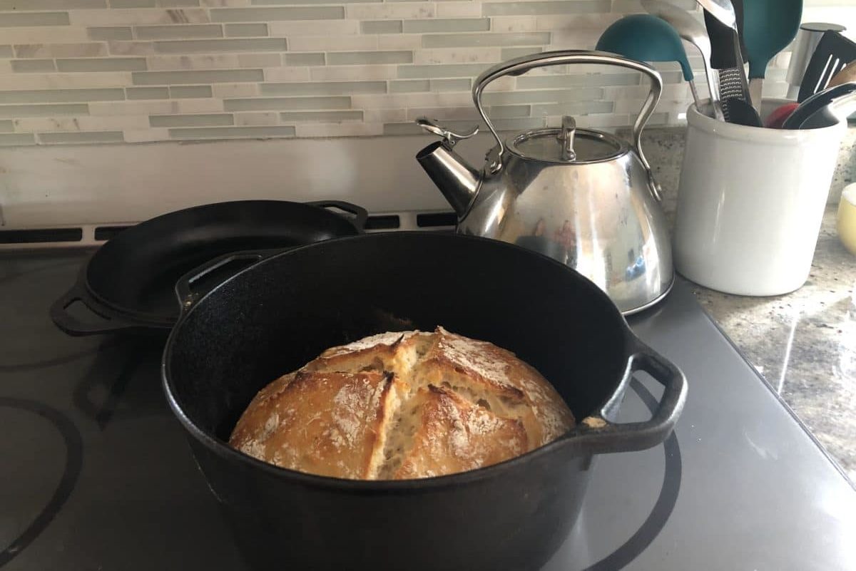 Sourdough bread baking inside a Dutch oven.