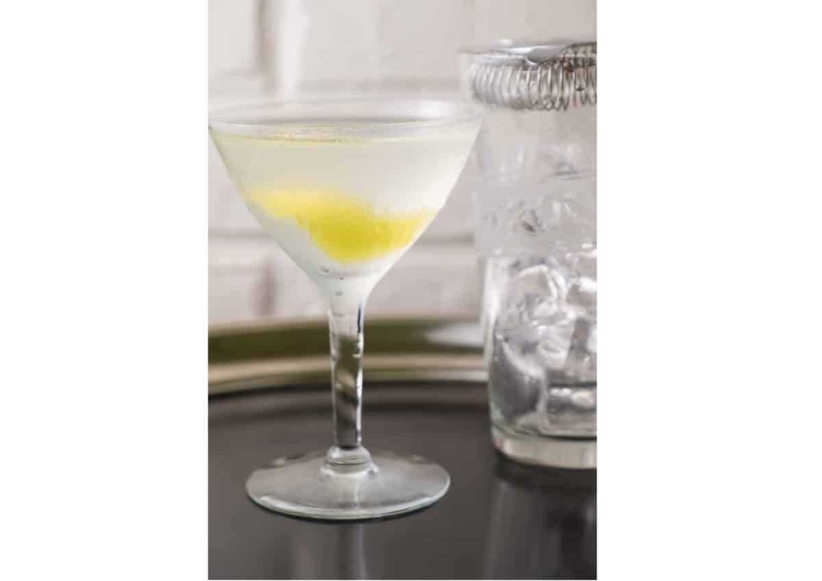 Elegant martini glass with a lemon peel twist and Vesper cocktail