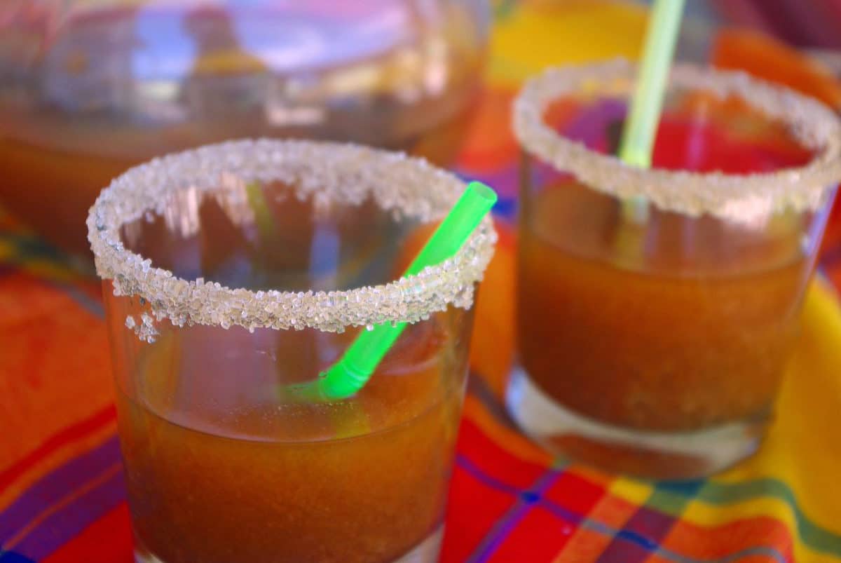 Two glasses of Tamarind Punch with salted rims and straws