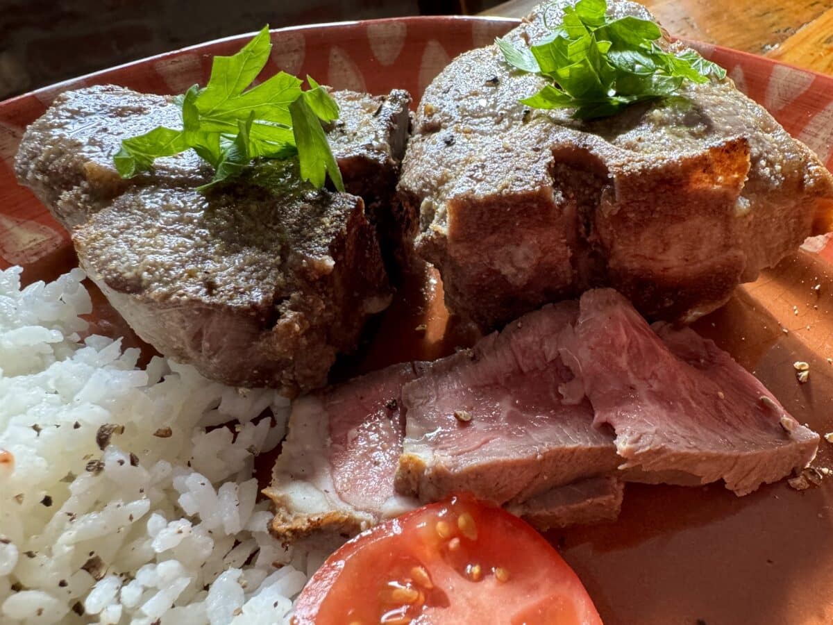 lamb chops plated with sald
