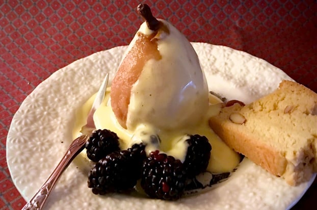 Zabaglione dessert served with blackberries and a pear slice