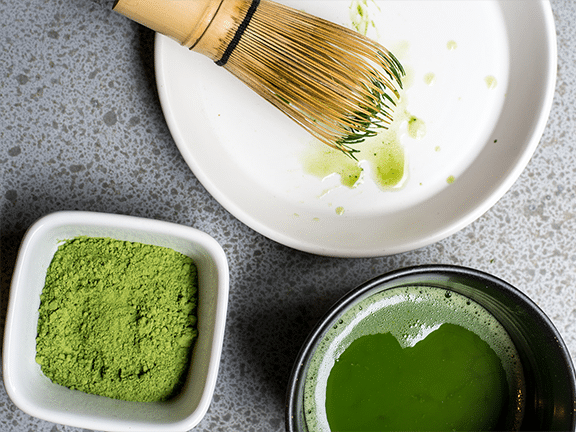 match powder in a dish with whisk