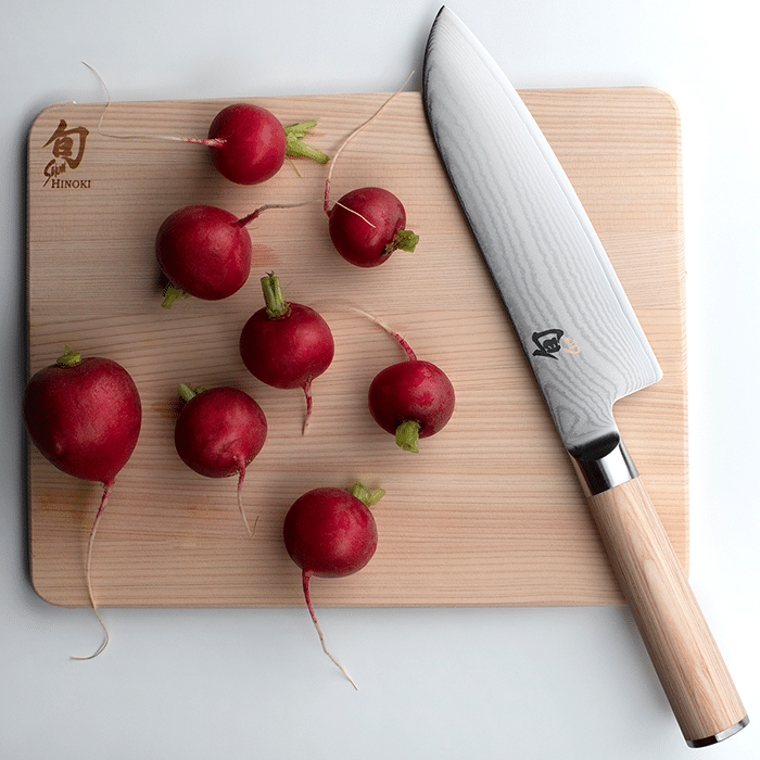 Blonde Shun Santoku with radishes on cutting bpard
