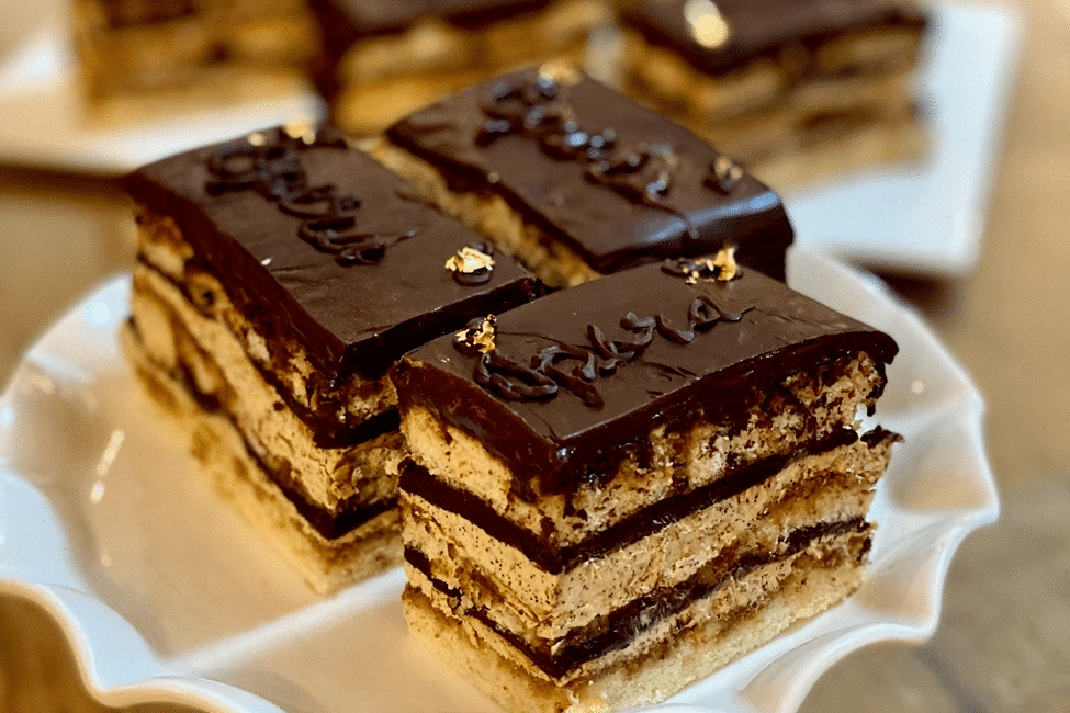 Gourmet layered opera cake with chocolate glaze.