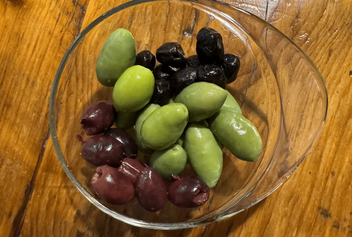 Bowl of olives on a wooden table